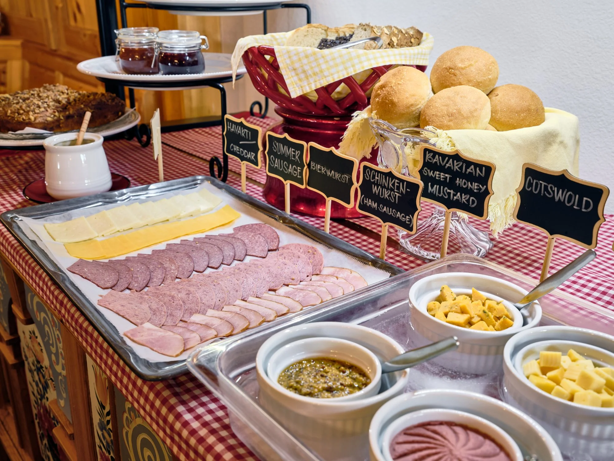 The Pension Anna breakfast buffet spread on the hand-painted Bavarian sideboard with meats, cheeses, breads and chalkboard labels