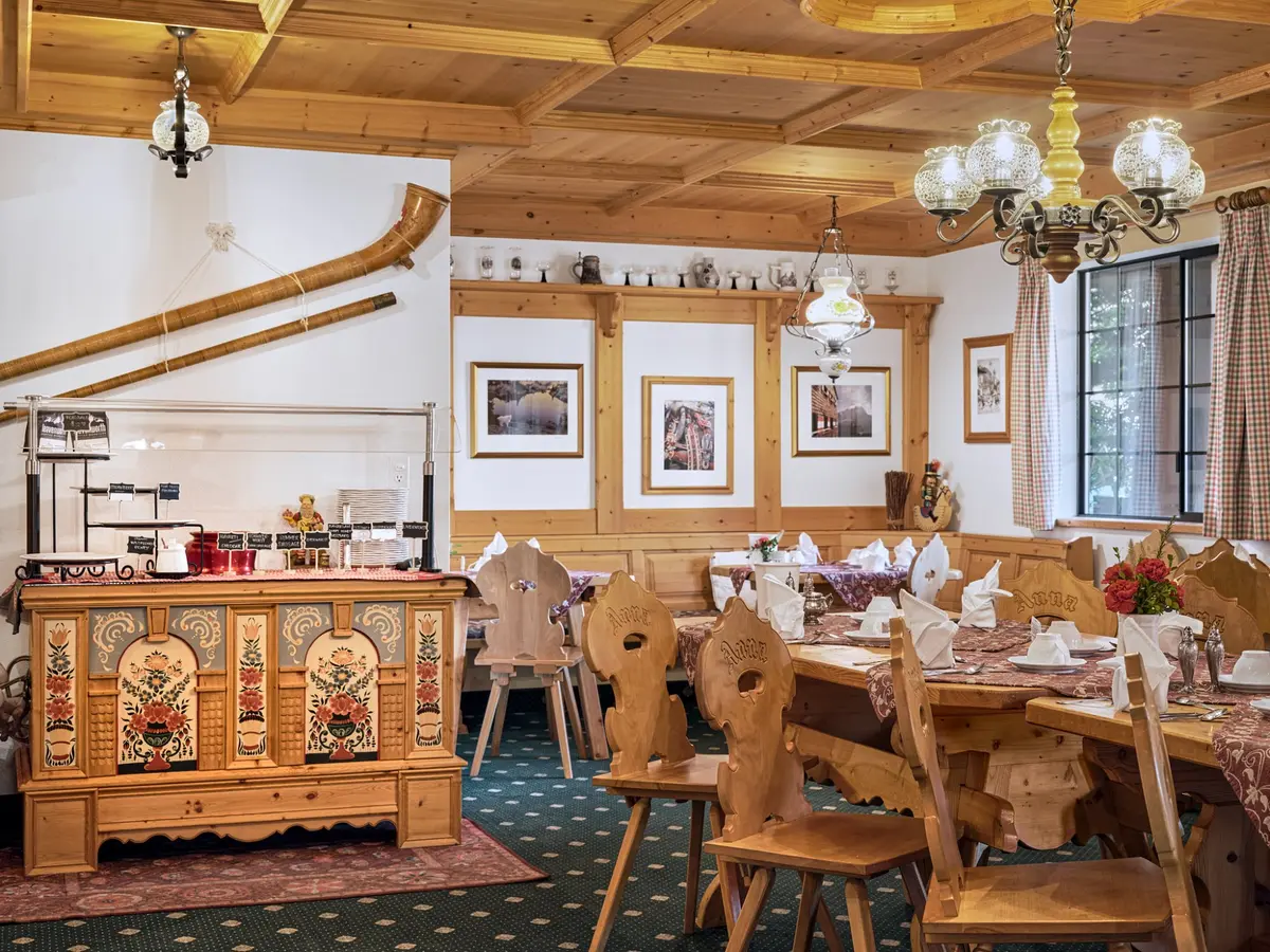 The Pension Anna Stube — hand-carved pine ceiling, painted Bavarian sideboard, and Anna chairs