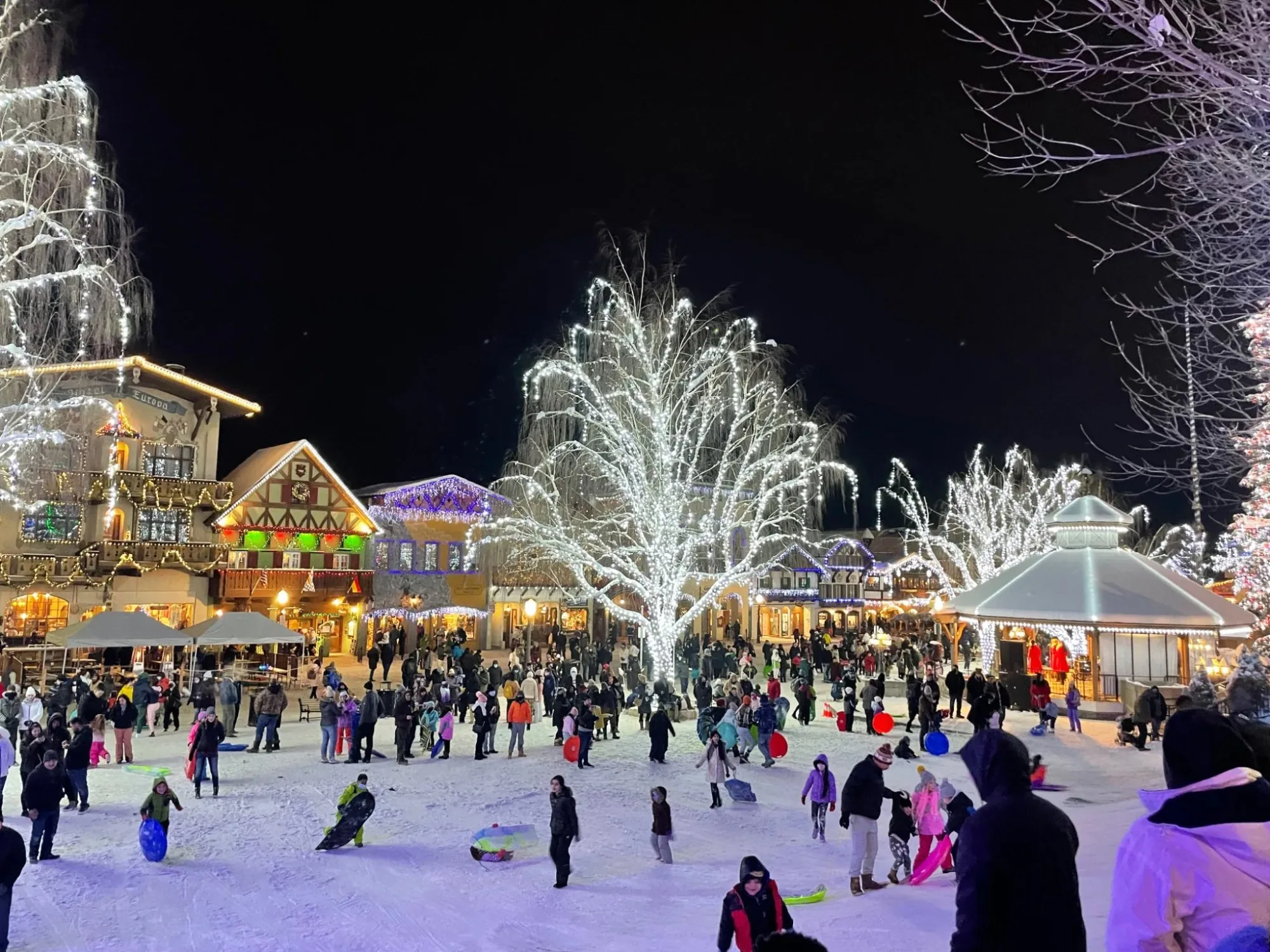 Leavenworth Village of Lights festival with hundreds of families sledding and celebrating in the village square