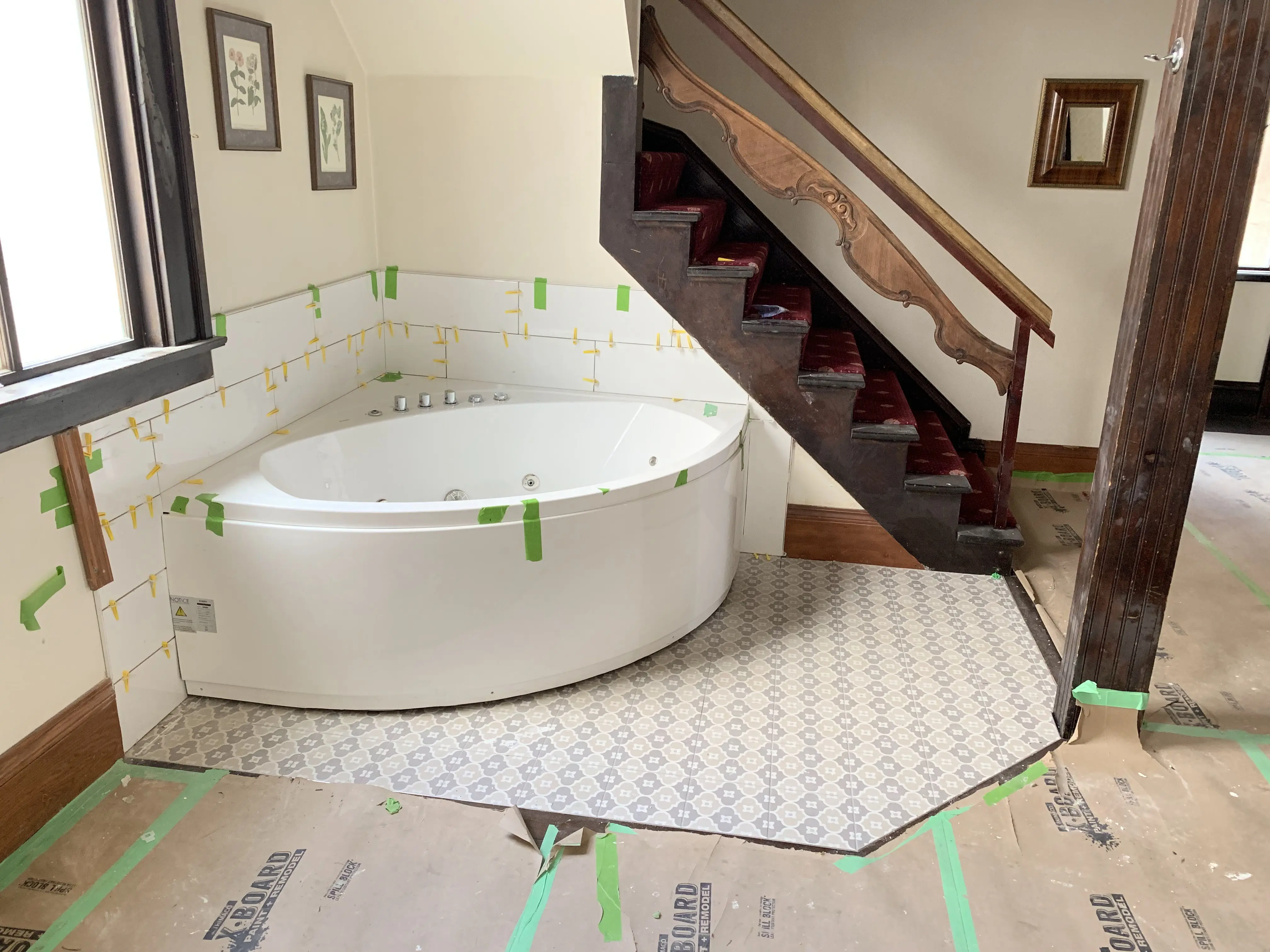 Jacuzzi tub being installed in the Alte Kapelle suite alongside the original carved wooden staircase
