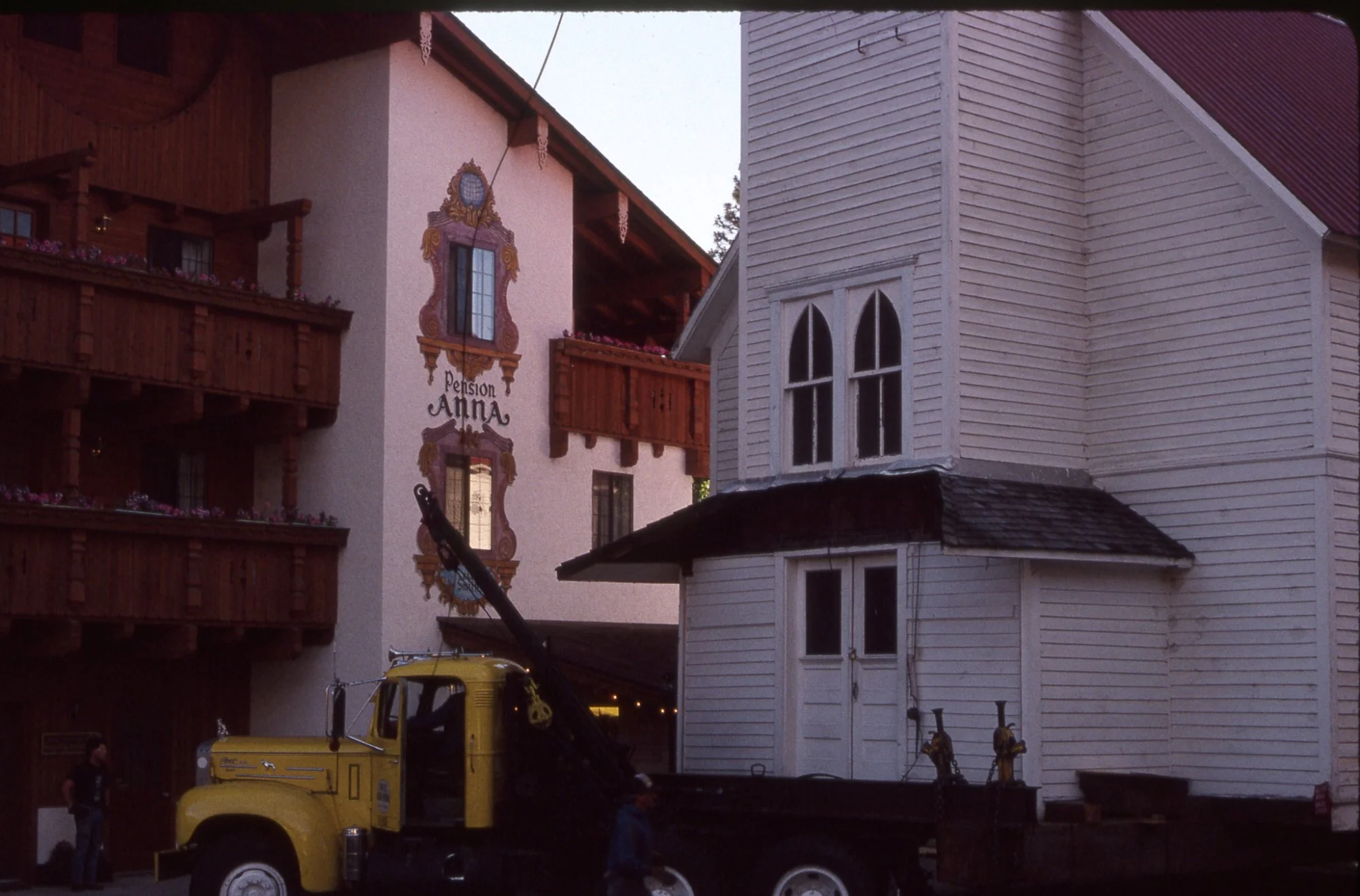 The chapel arriving beside Pension Anna, the hotel's painted sign visible on the building