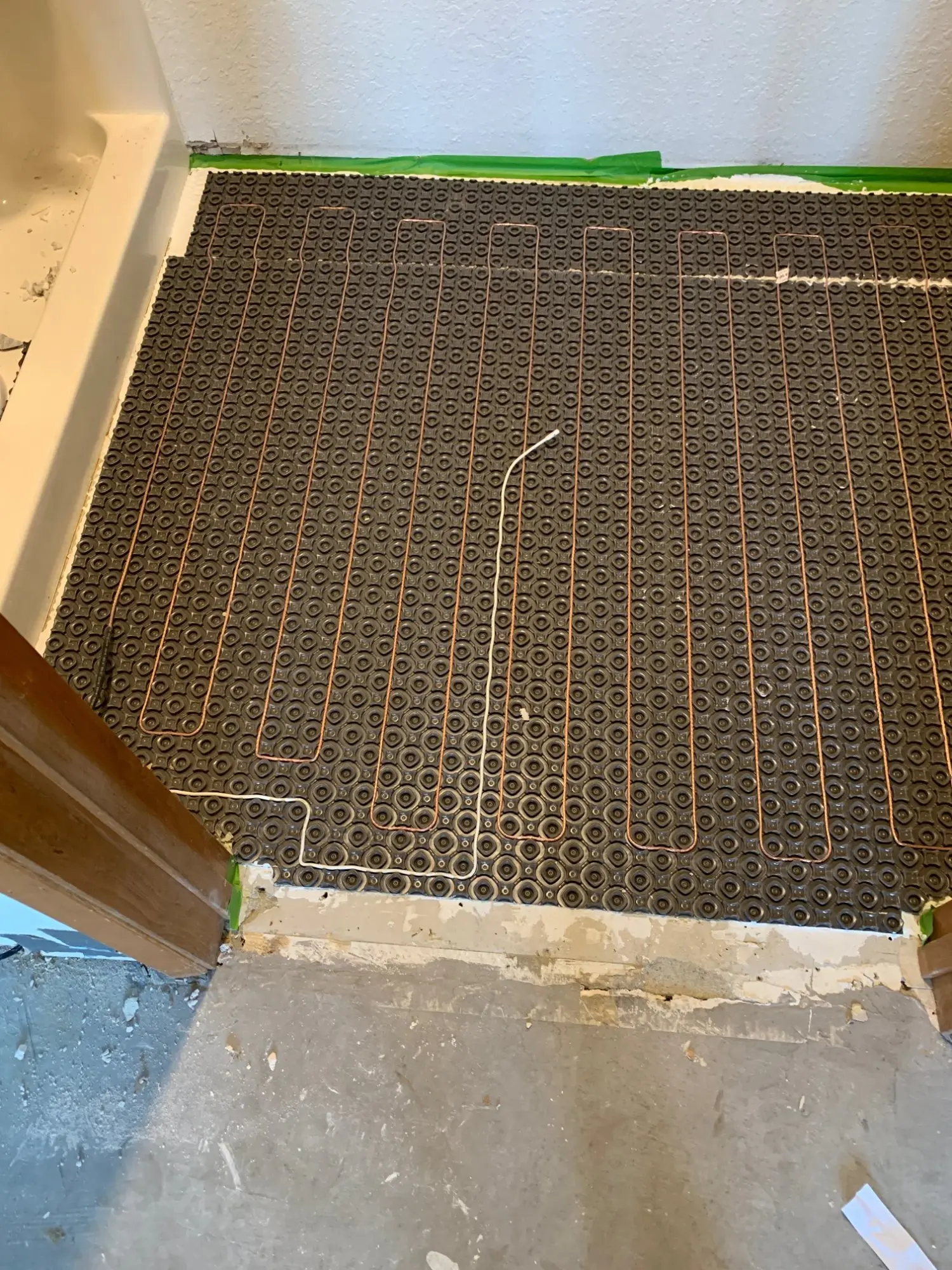 Radiant heating coils laid into bathroom subfloor during the 2019 Pension Anna remodel