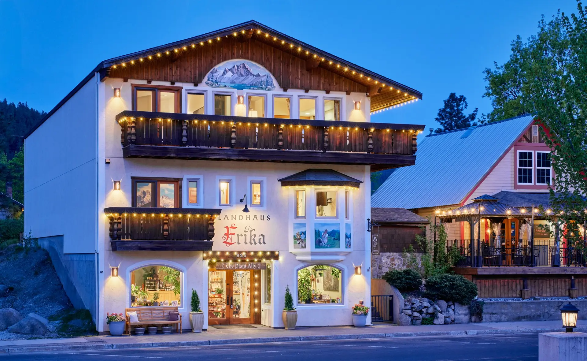 Landhaus Erika exterior at blue hour with string lights, Leavenworth