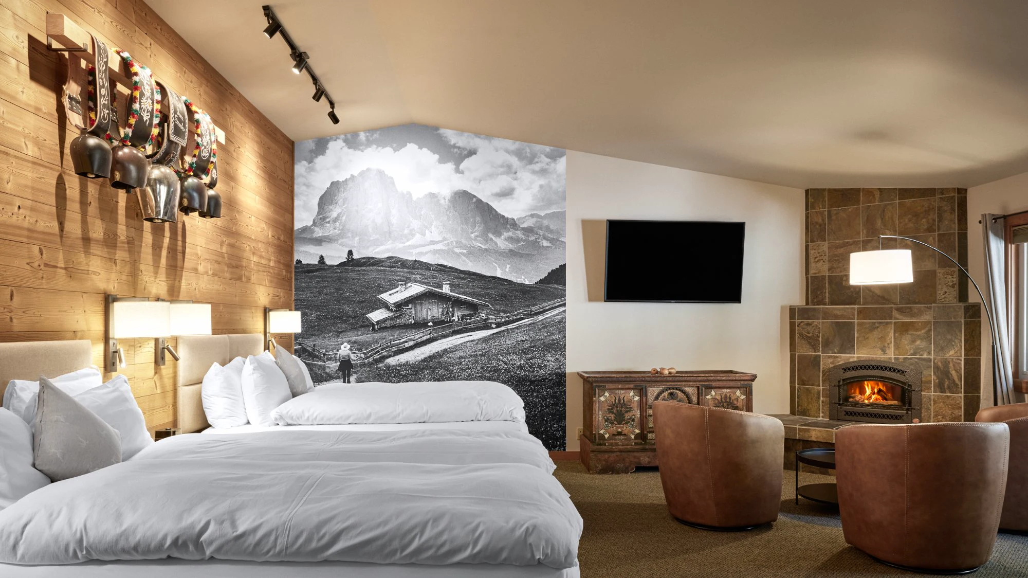 Autumn Suite two queen beds, cowbell rack, alm mural, and fireplace
