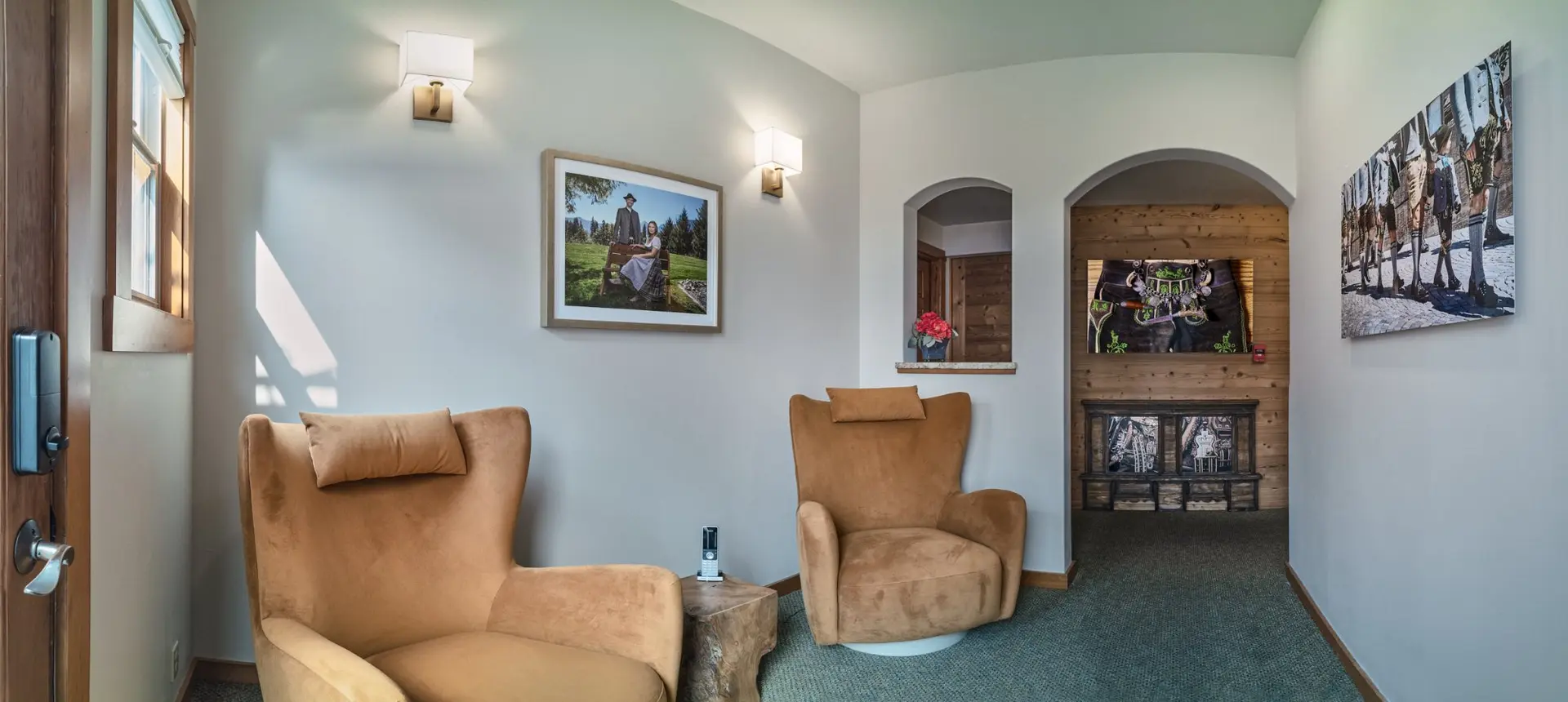 Landhaus Erika entryway sitting area near sauna with Tirolean photography on the walls