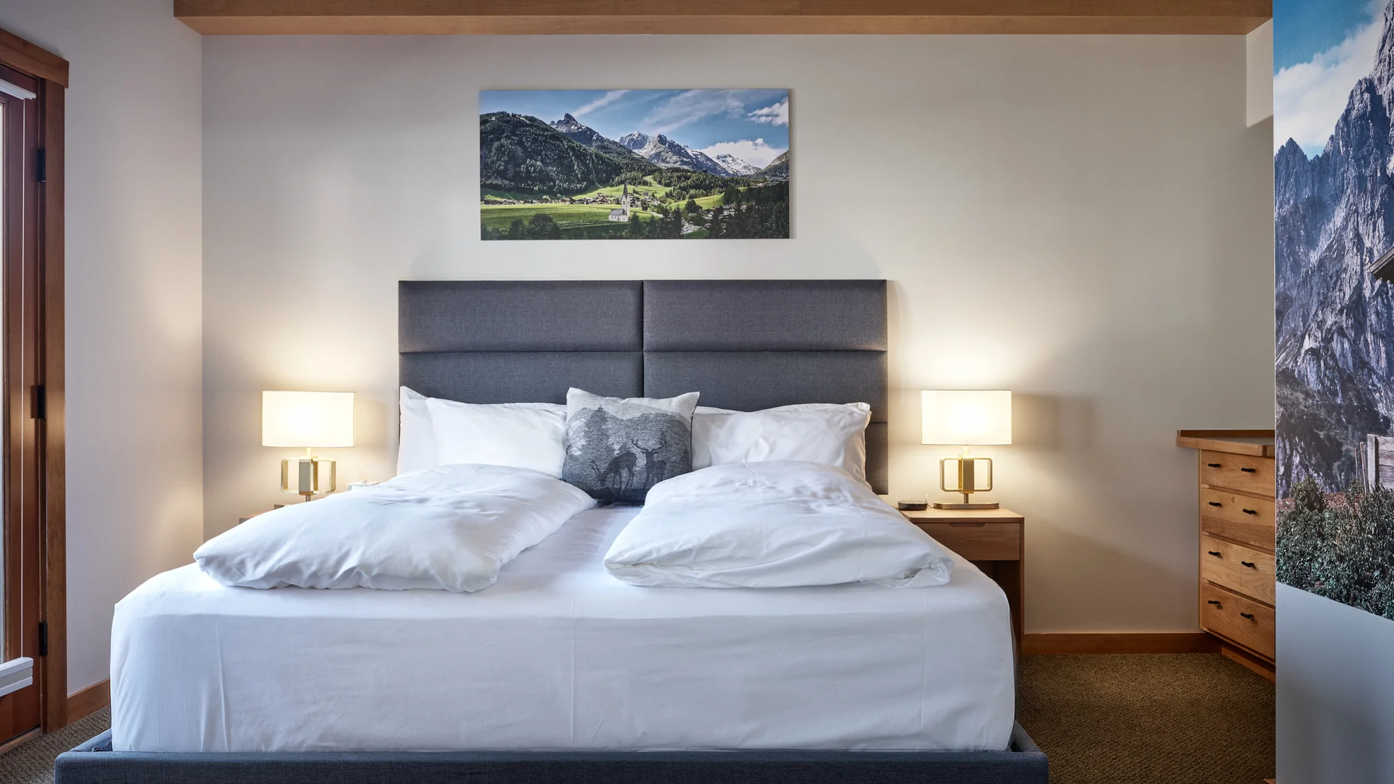 Solstice Suite king bed with alpine landscape art