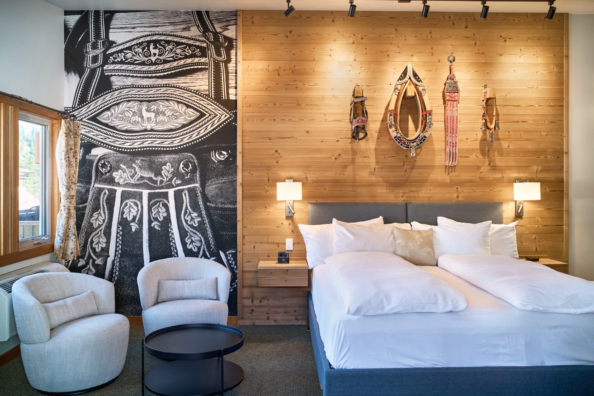 Summer Suite bedroom with lederhosen mural and horse harness wall