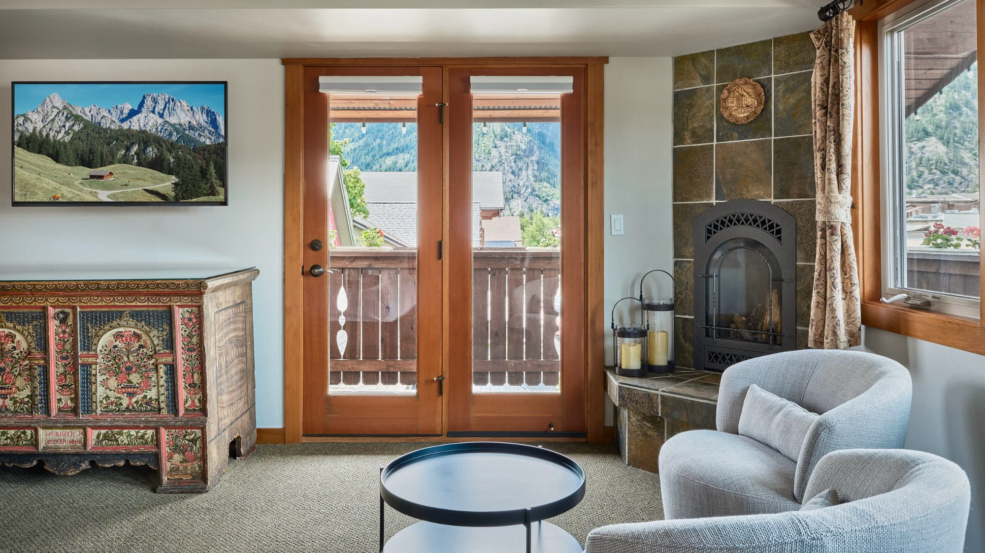 Summer Suite sitting area with 1804 Truhe, fireplace, and balcony doors