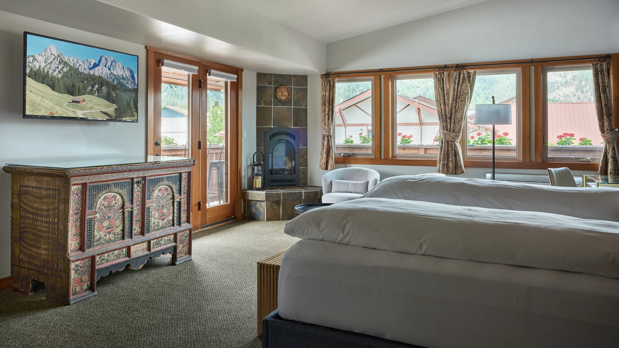 Summer Suite with 1804 Truhe, fireplace, and mountain views through windows