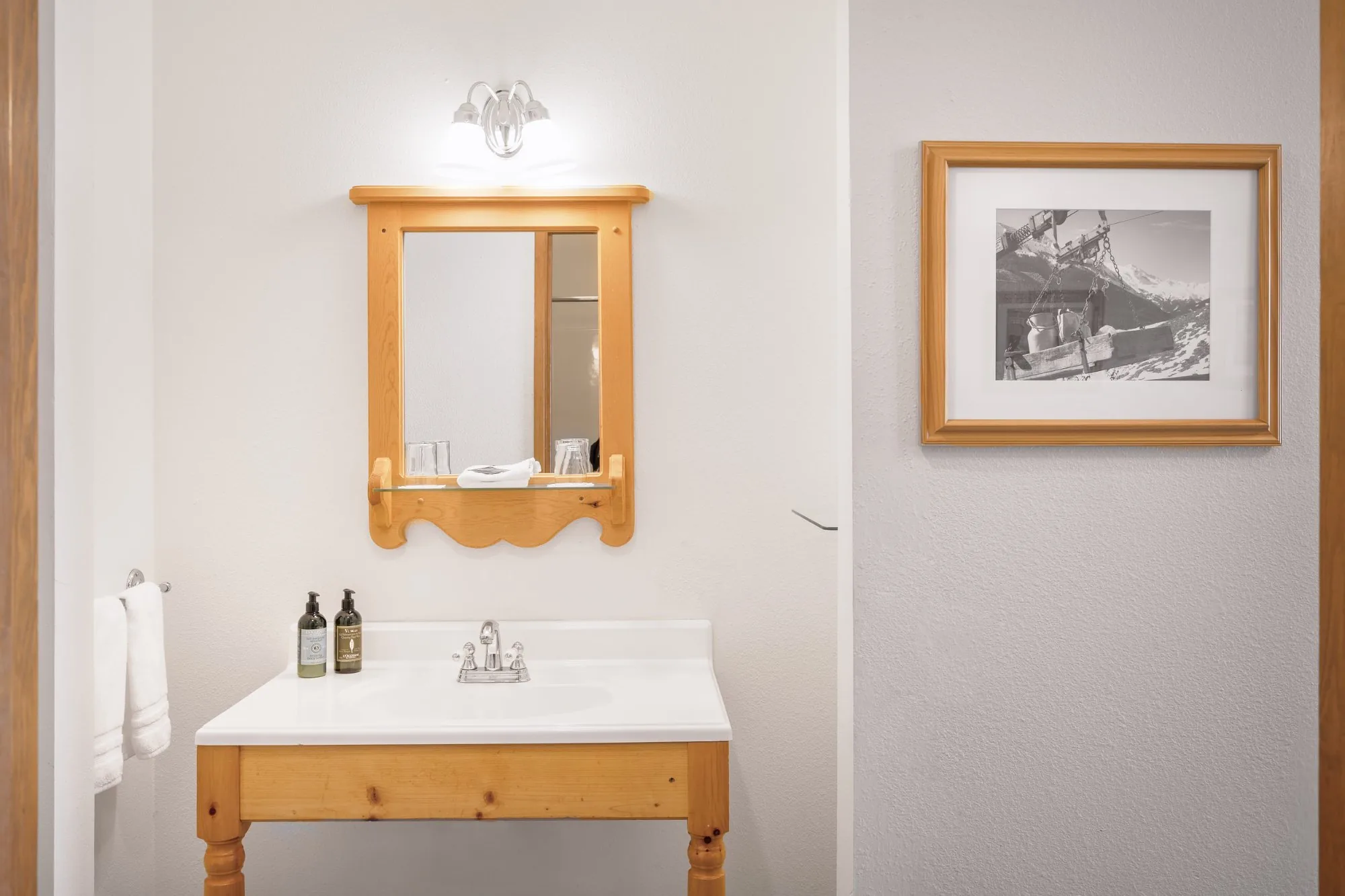 Alpbachtal — bathroom vanity with pine mirror and L'Occitane amenities