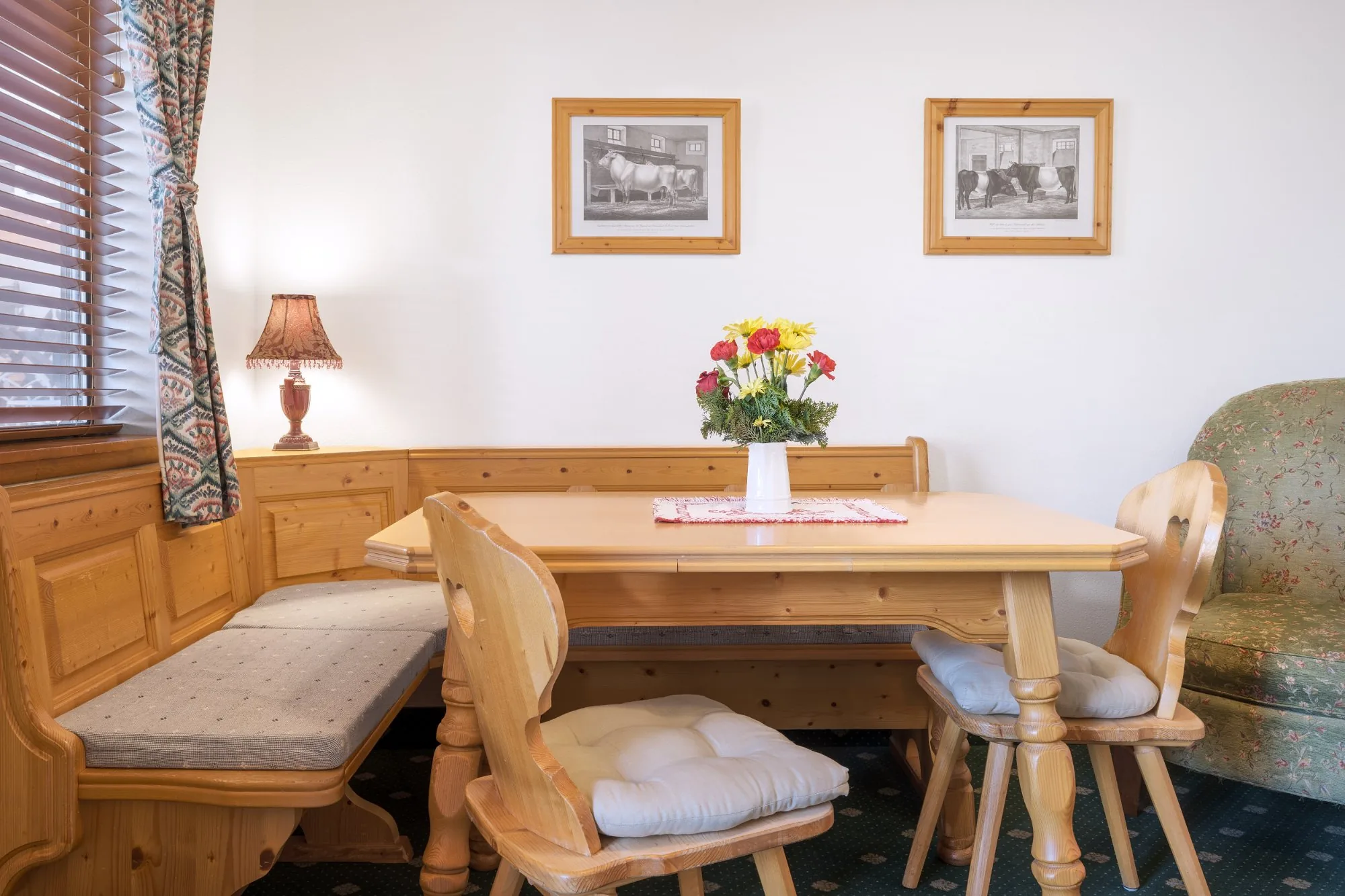 Alpbachtal — pine corner booth nook with lamp and flowers