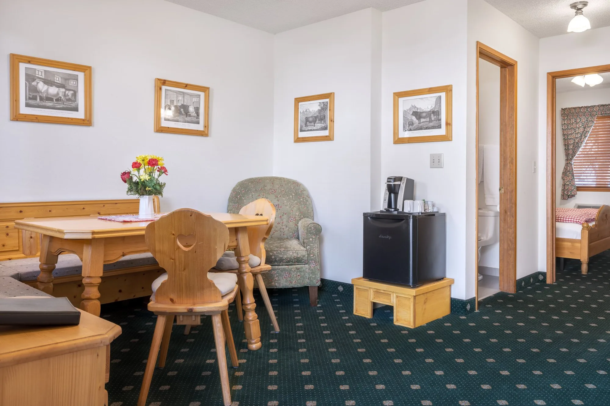 Alpbachtal — sitting room with pine stube, cattle prints, and mini fridge