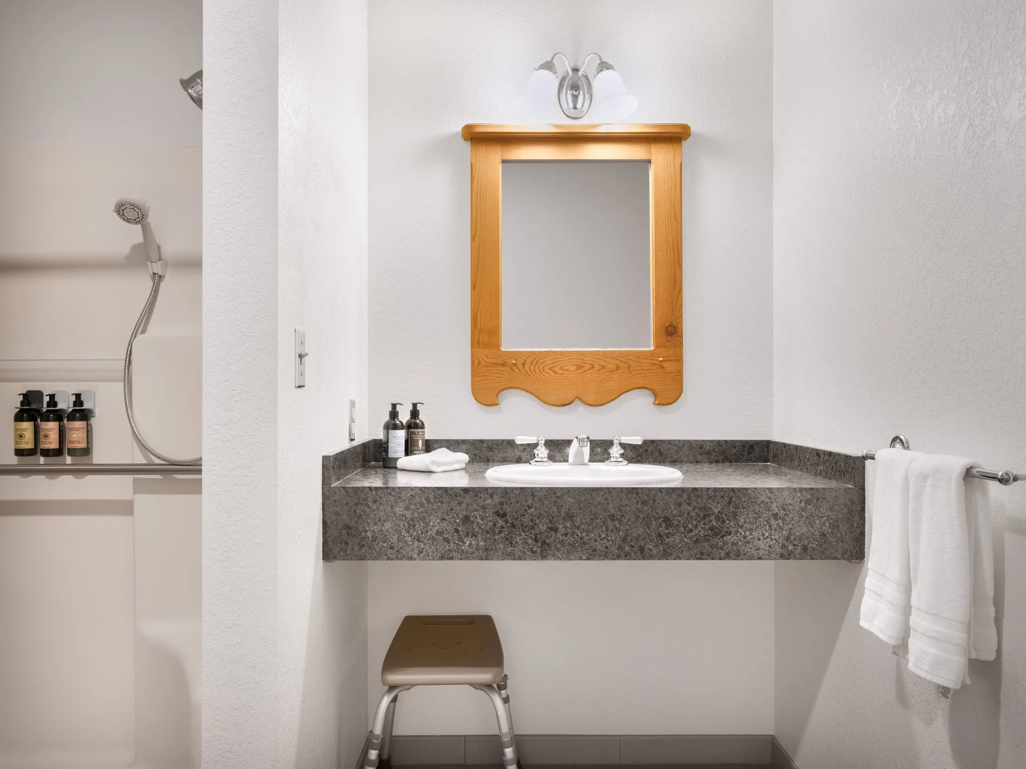 Inntal — ADA bathroom with granite vanity and L'Occitane amenities