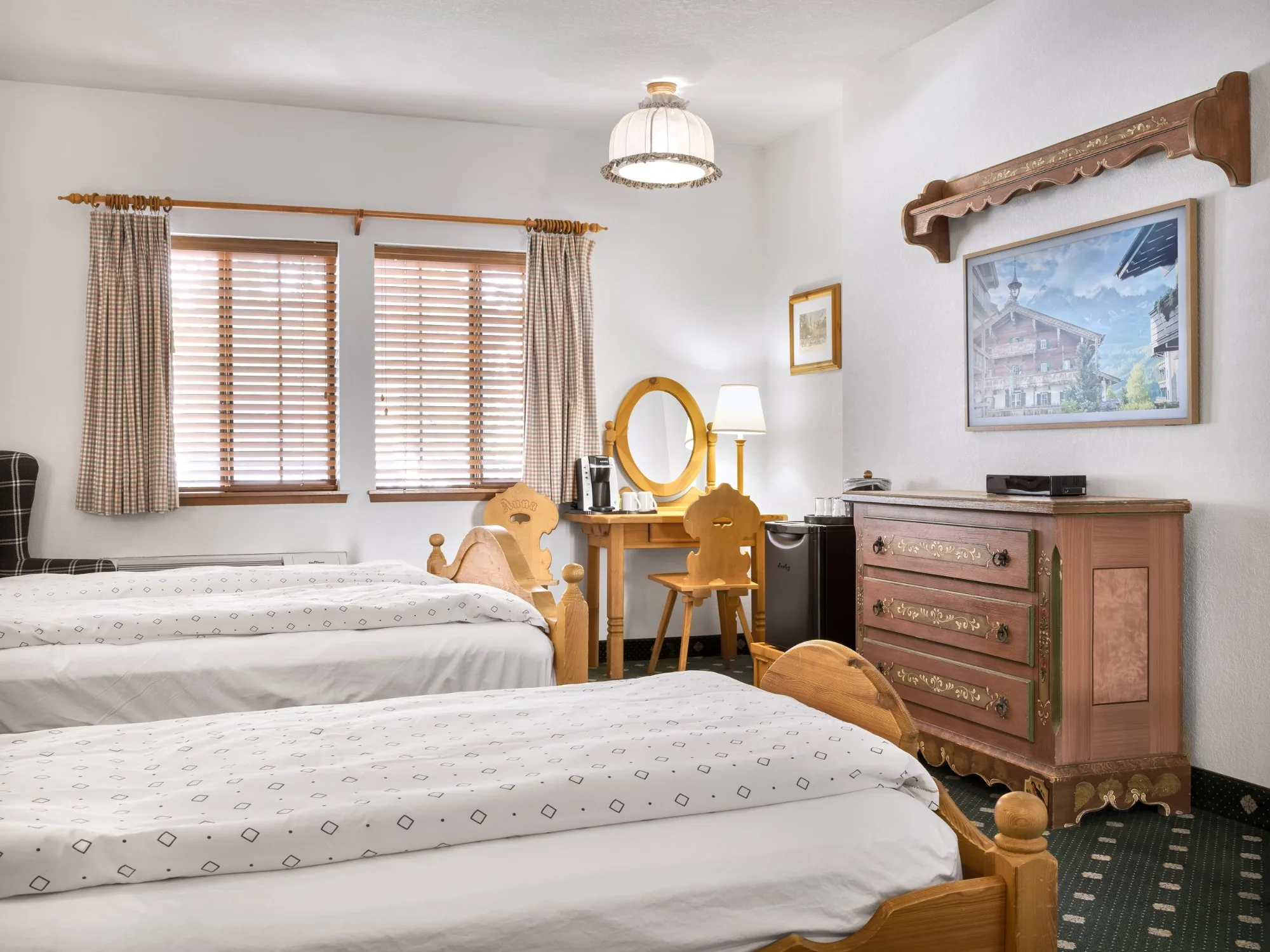 Inntal — twin beds with painted folk dresser and Frame TV